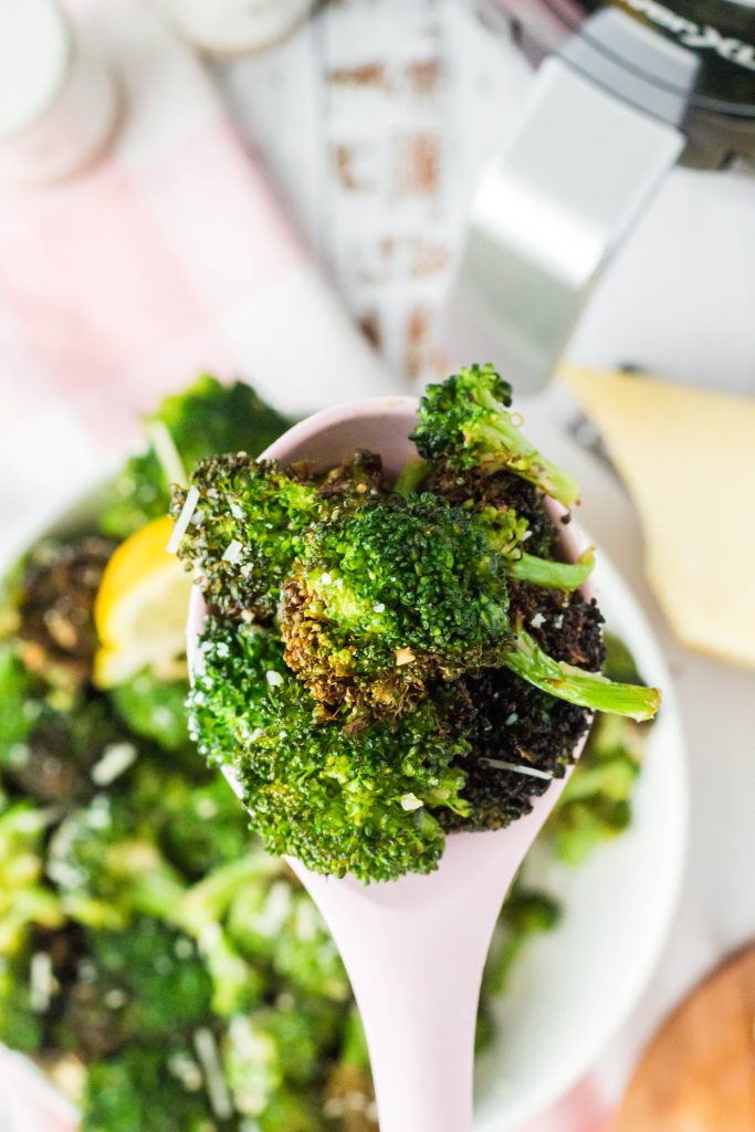 Air fryer broccoli in a serving spoon.