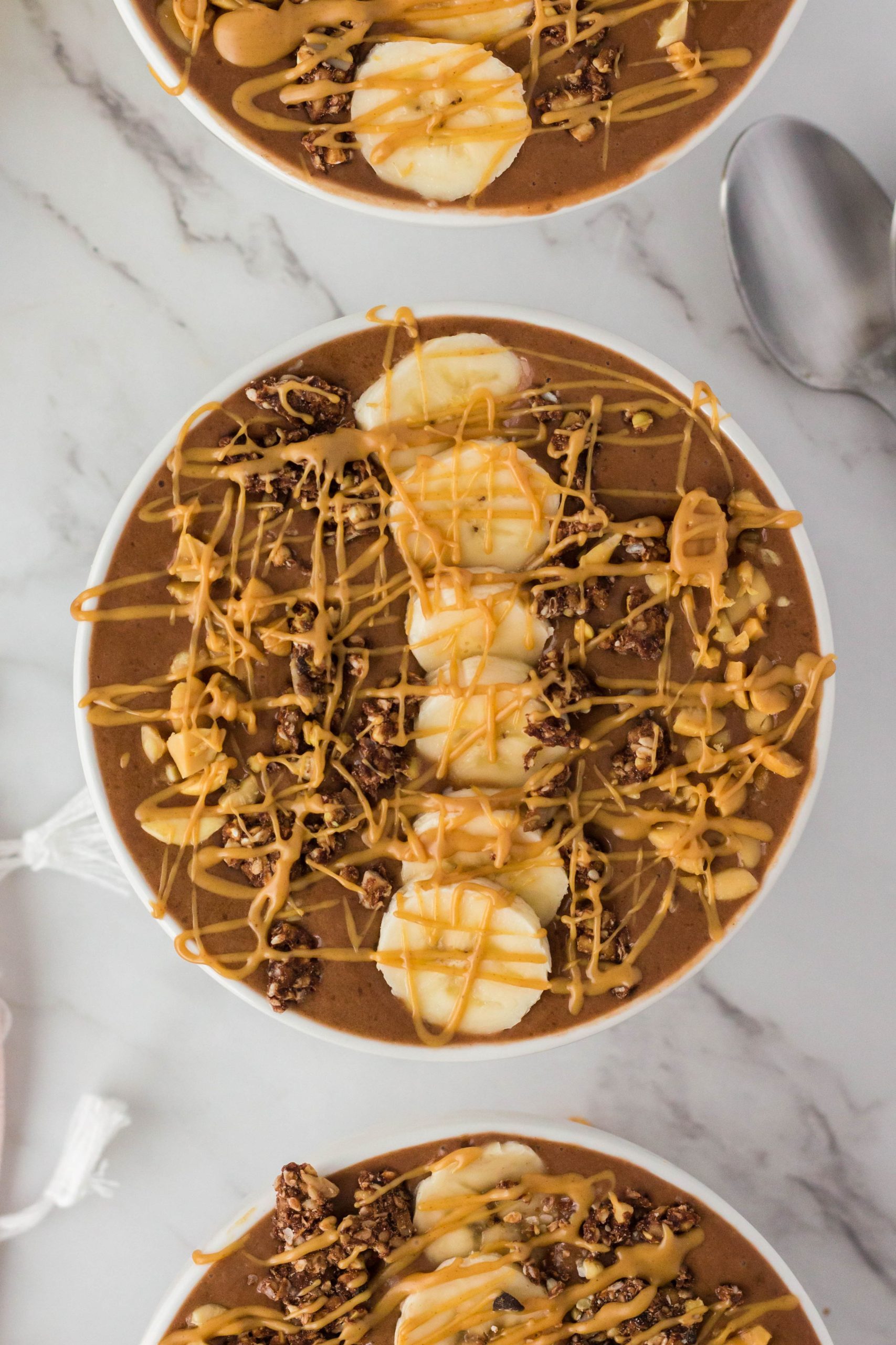 Super delicious and easy to make this Chocolate Peanut Butter Smoothie Bowl is comfort in a bowl. Filled with bananas, cacao powder, peanut butter, and dates you can enjoy this smoothie bowl guilt-free!