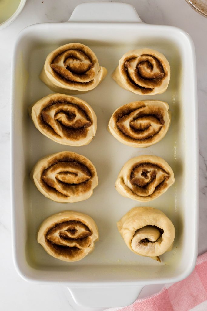 Raw vegan cinnamon rolls in a pan ready to bake.