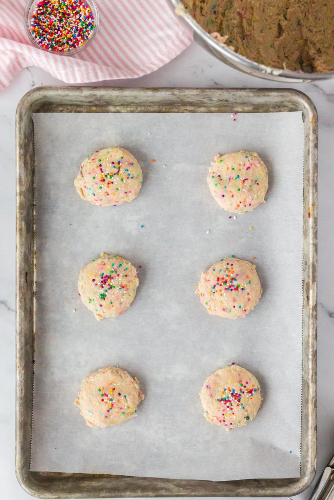 Add cookie dough balls to a parchment lined baking sheet