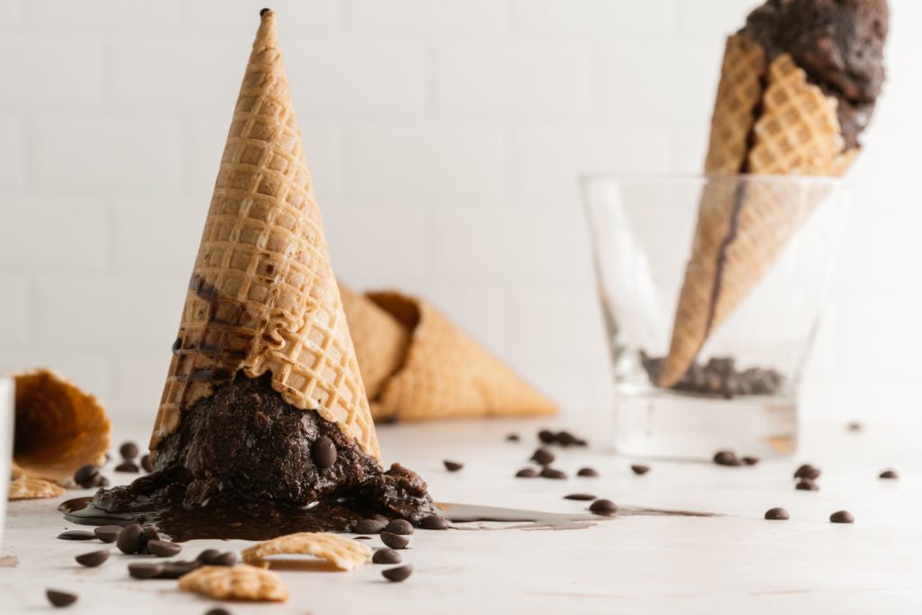 Vegan chocolate sorbet cone upside down on a table