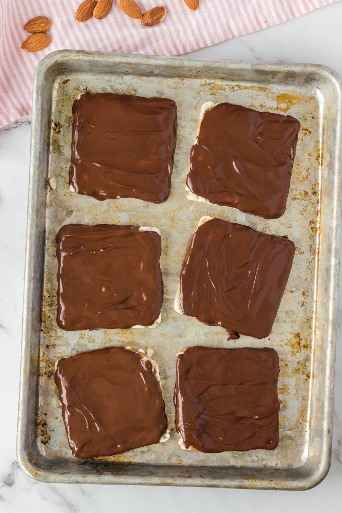 Chocolate coated rice cakes on a cookie sheet.