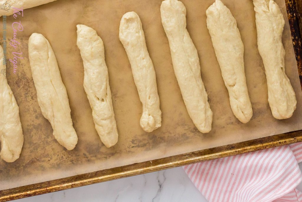 Breadsticks on a parchment lined baking sheet.