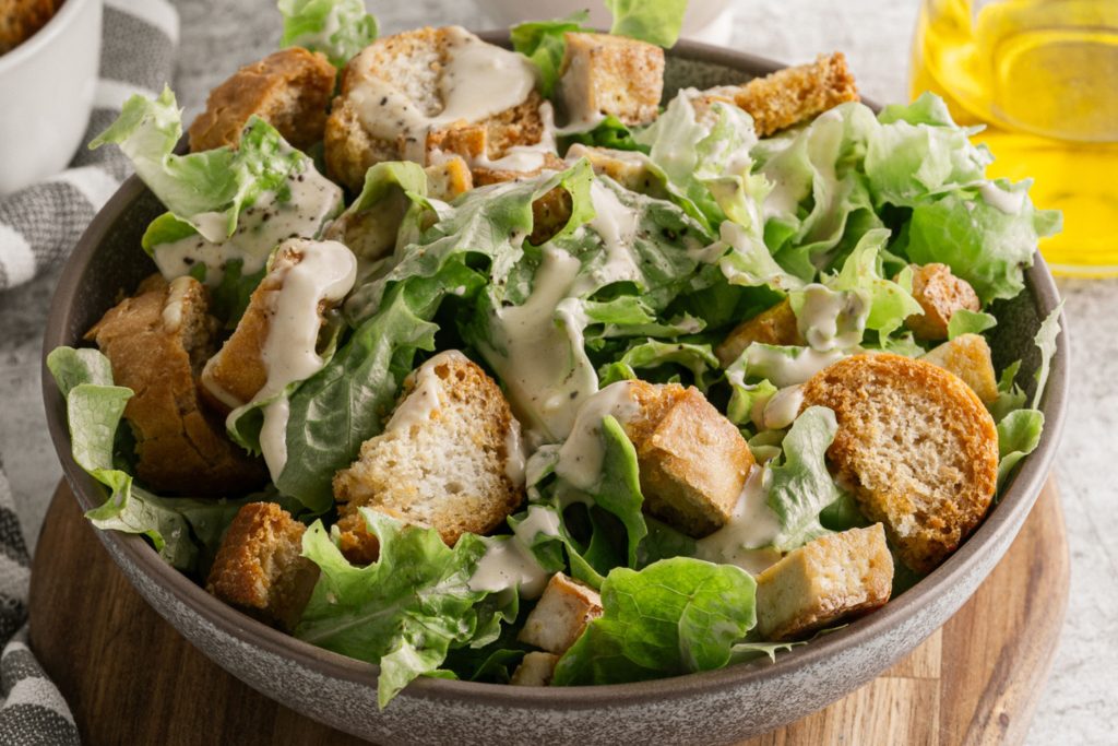 A close up view of the vegan caesar salad in a bowl.
