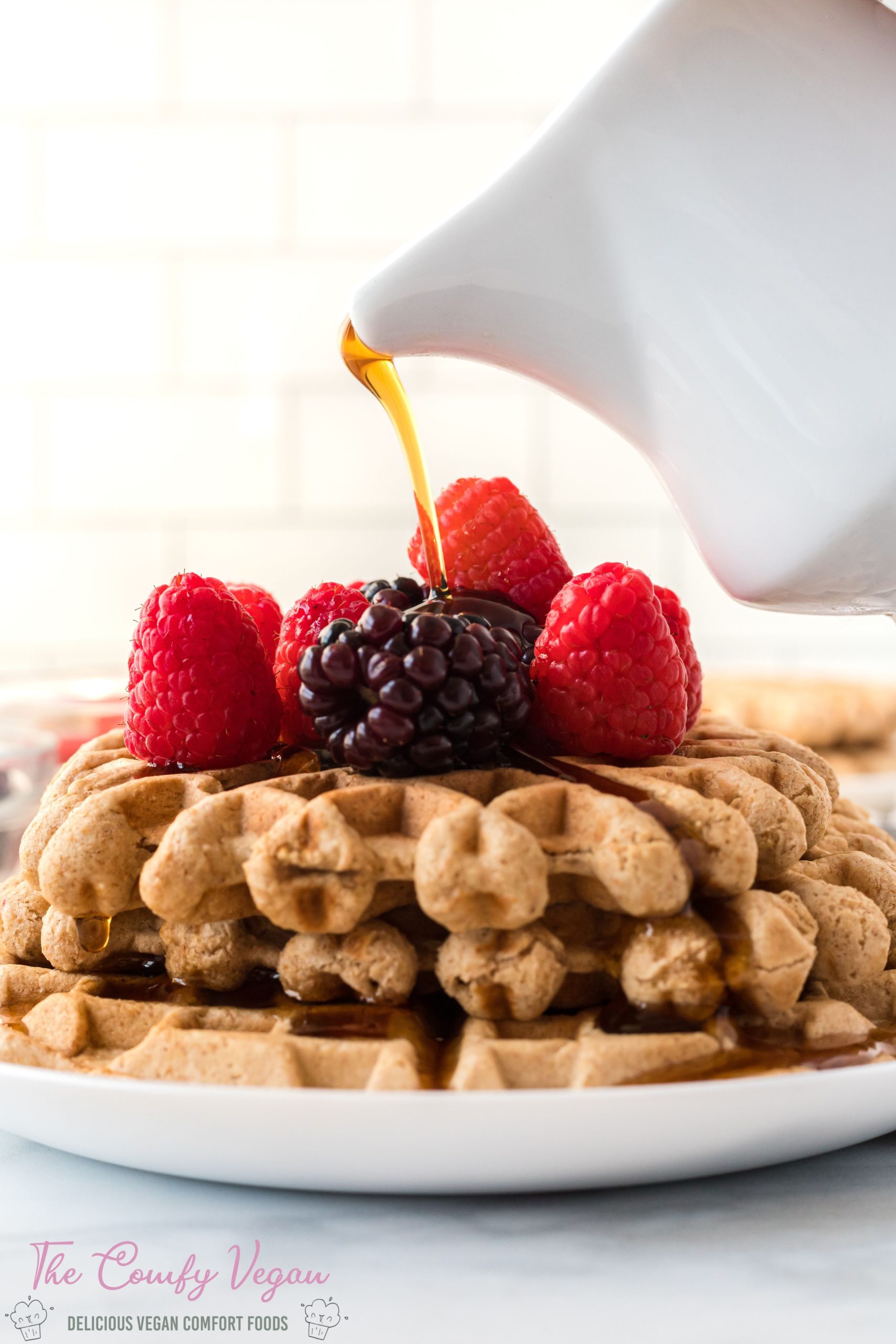 Easy Vegan Waffles! This vegan waffles recipe is so quick and easy to make. Filled with whole wheat flour, oats, and almond flour these waffles are hearty and taste amazing. Ready to enjoy in less than 15 minutes.