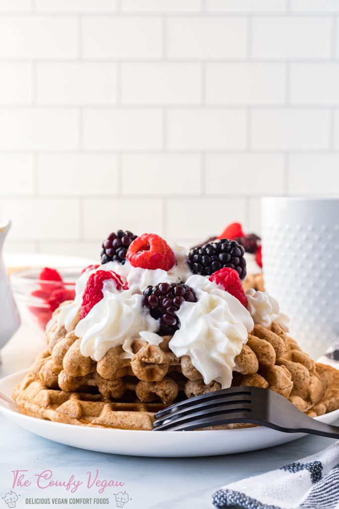 waffles topped with berries and vegan whipped cream.