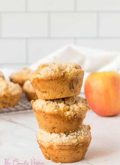 3 vegan apple muffins stacked on top of each other.