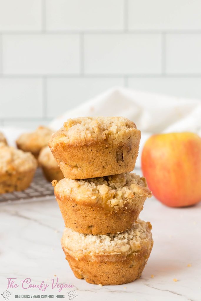 3 vegan apple muffins stacked on top of each other.