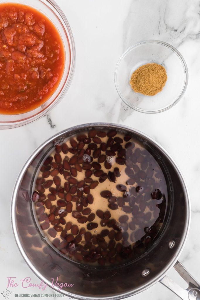 Black beans and veggie broth in a saucepan.